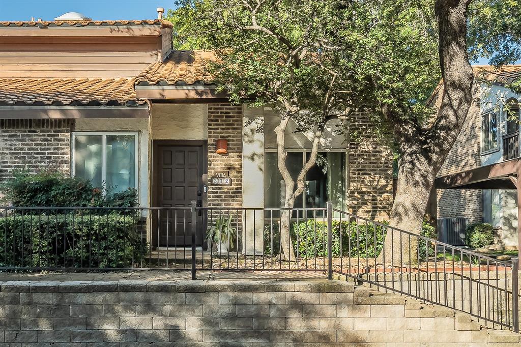 14151 Montfort Drive, Unit 332 Dallas, TX 75254 - Photo 2 of 35 a view of a brick house with large windows