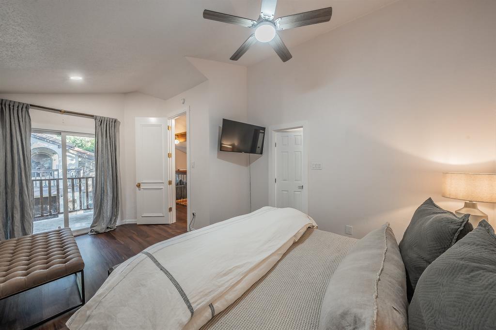 14151 Montfort Drive, Unit 332 Dallas, TX 75254 - Photo 26 of 35 a bedroom with a bed and a flat screen tv