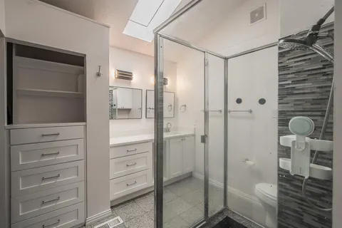 a bathroom with a shower and toilet