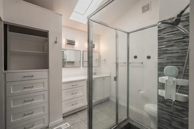 a bathroom with a shower and toilet