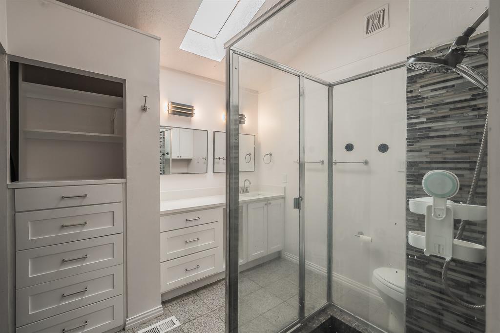 14151 Montfort Drive, Unit 332 Dallas, TX 75254 - Photo 27 of 35 a bathroom with a shower and a toilet