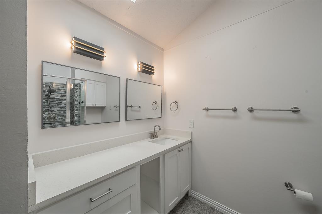 14151 Montfort Drive, Unit 332 Dallas, TX 75254 - Photo 29 of 35 a bathroom with a sink and a mirror