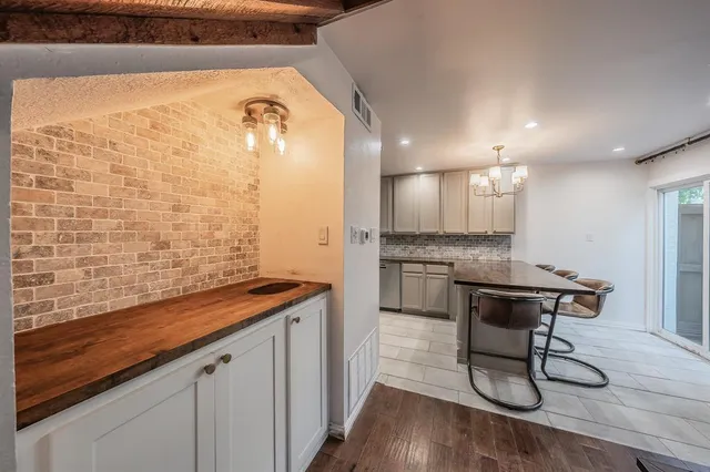 a bathroom with a granite countertop sink a mirror and shower