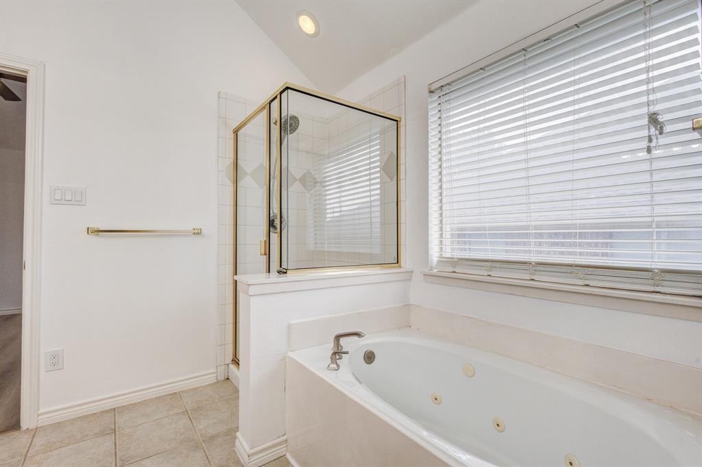 12405 Ark Road Frisco, TX 75035 - Photo 15 of 34 Full bath with a stall shower, vaulted ceiling, a jetted tub, light tile patterned floors, and recessed lighting