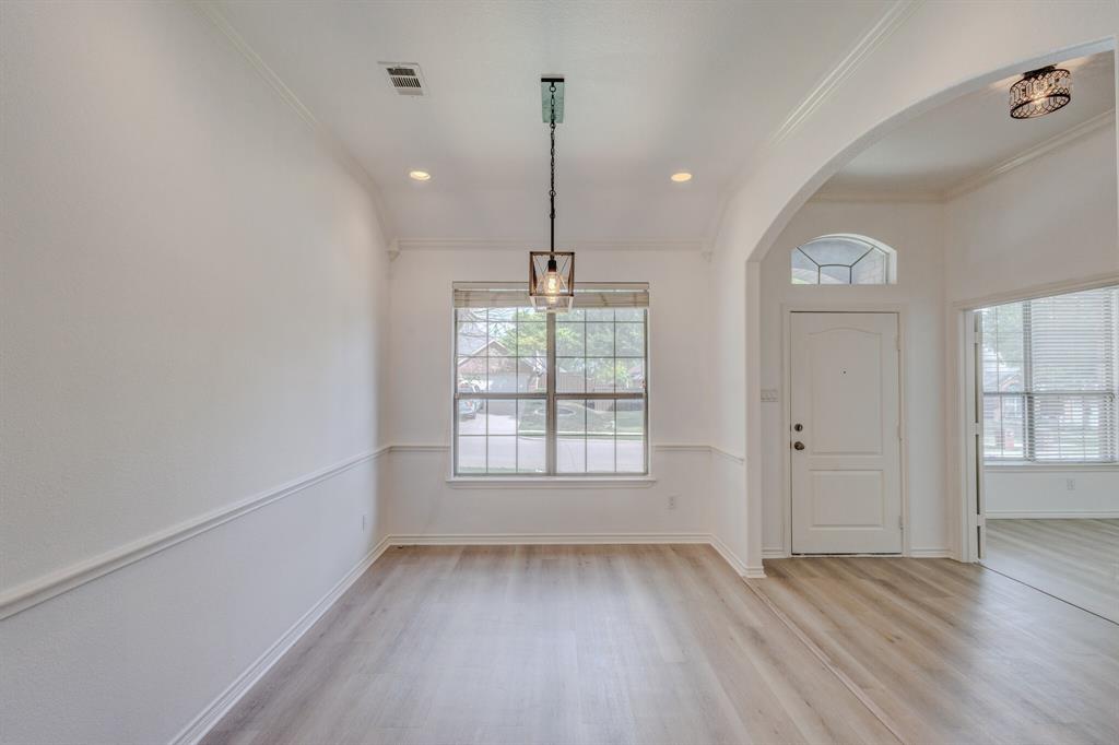 12405 Ark Road Frisco, TX 75035 - Photo 5 of 34 Foyer entrance with light wood-style floors, arched walkways, recessed lighting, and crown molding