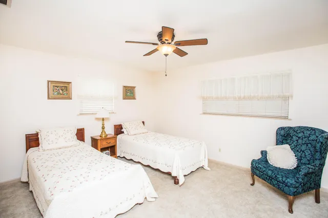a bedroom with two beds and painting on the wall