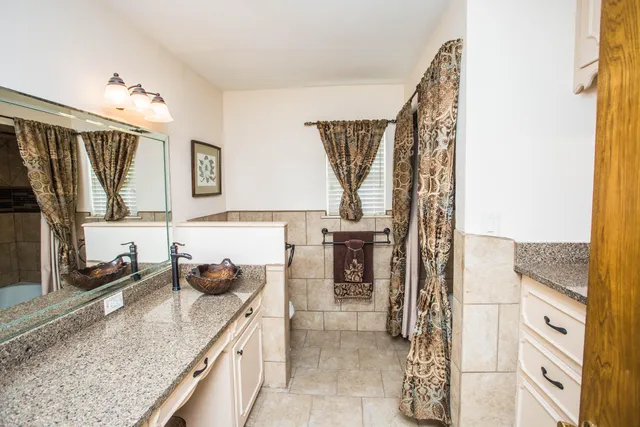a kitchen with a granite countertop sink a stove and a wooden floors