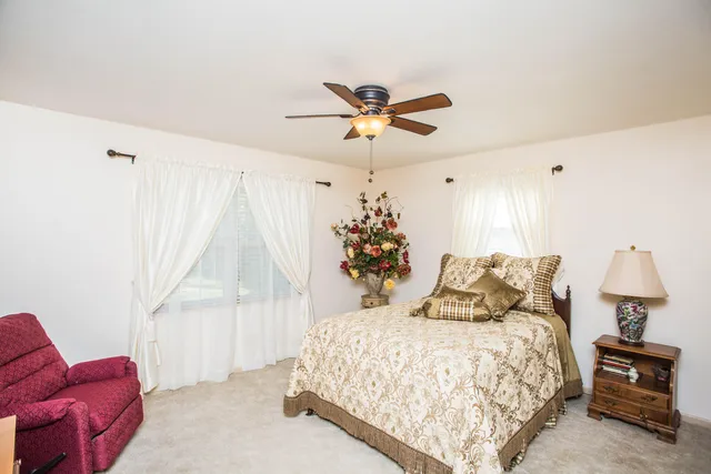 a bedroom with a bed couch and window
