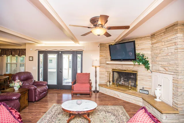 a living room with furniture a fireplace and a flat screen tv