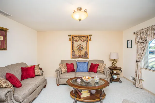 a living room with furniture and a chandelier