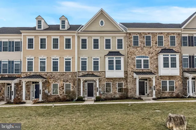 a front view of building with yard and green space