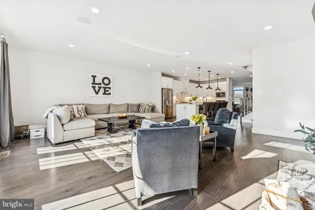 a living room with lots of furniture and kitchen view