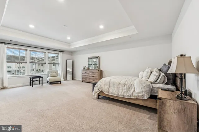 a spacious bedroom with a bed and a chair