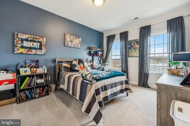 a bedroom with a bed and a desk