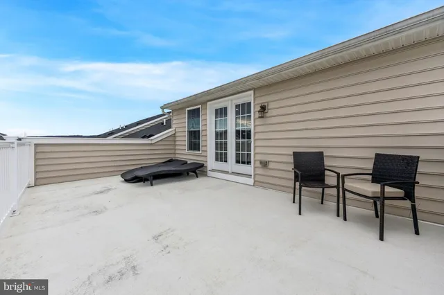 a view of house with backyard and furniture