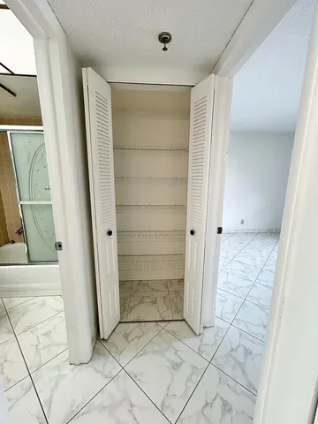 a view of an empty room with windows