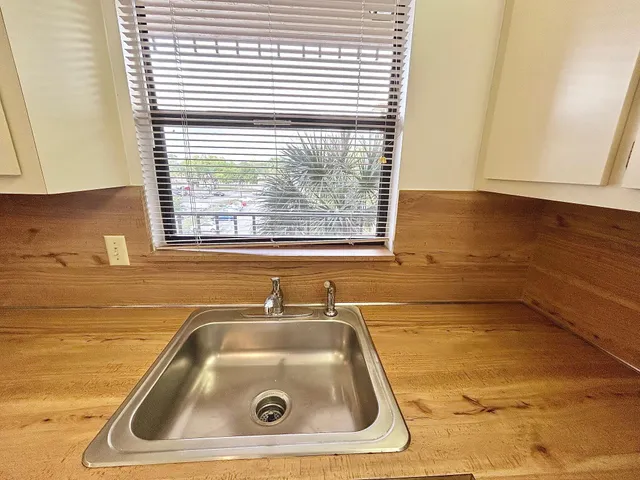 a bathroom with a sink and a window
