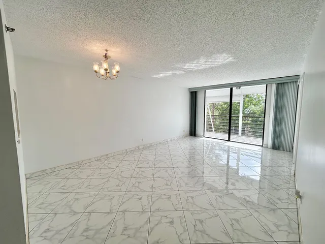 a view of empty room with a fireplace