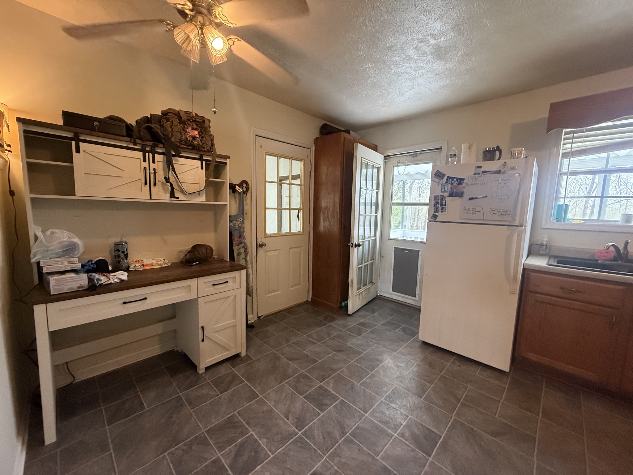 150 Deerwood Road Hohenwald, TN 38462 - Photo 18 of 56 a kitchen with a cabinets and white appliances