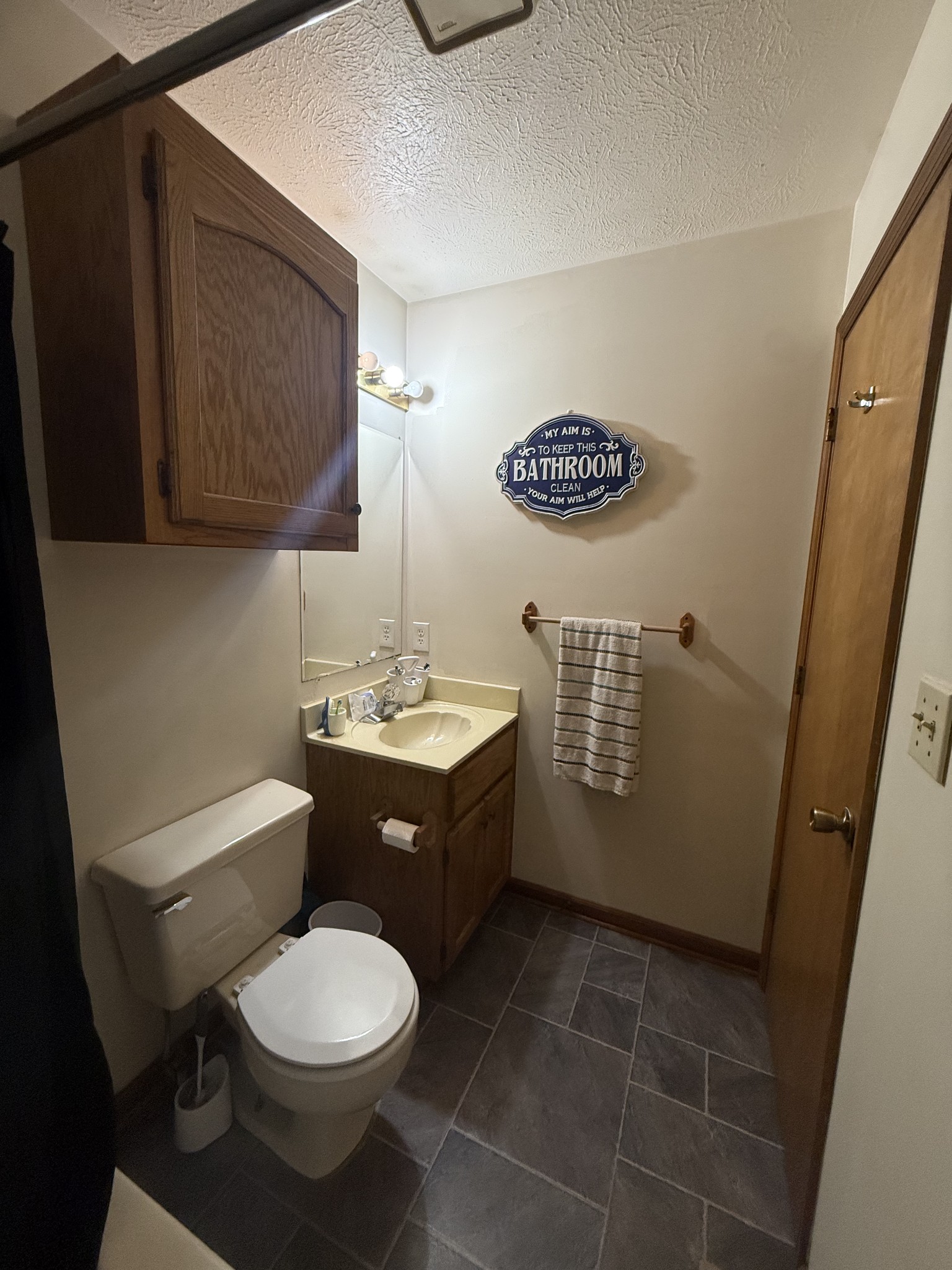 150 Deerwood Road Hohenwald, TN 38462 - Photo 24 of 56 a bathroom with a toilet a sink and mirror