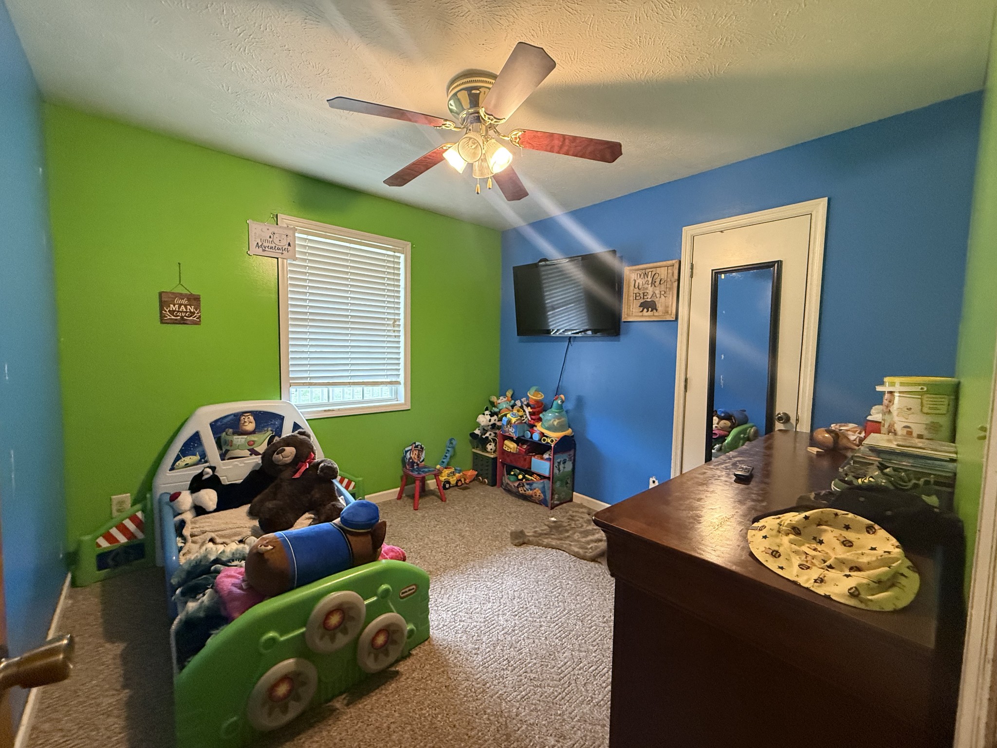 150 Deerwood Road Hohenwald, TN 38462 - Photo 25 of 56 a bedroom with a bed and a mirror