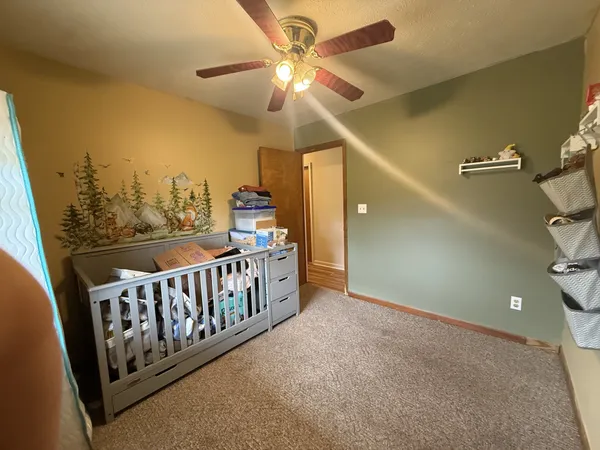 a bedroom with a bed and a chandelier