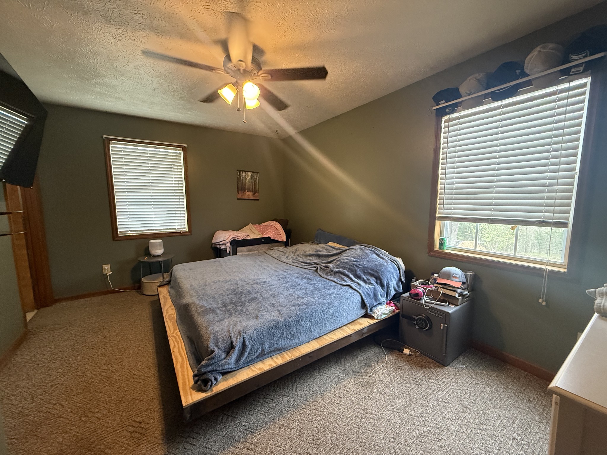 150 Deerwood Road Hohenwald, TN 38462 - Photo 31 of 56 a bedroom with a bed and a chandelier