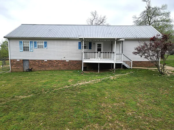 a front view of a house with a garden and deck