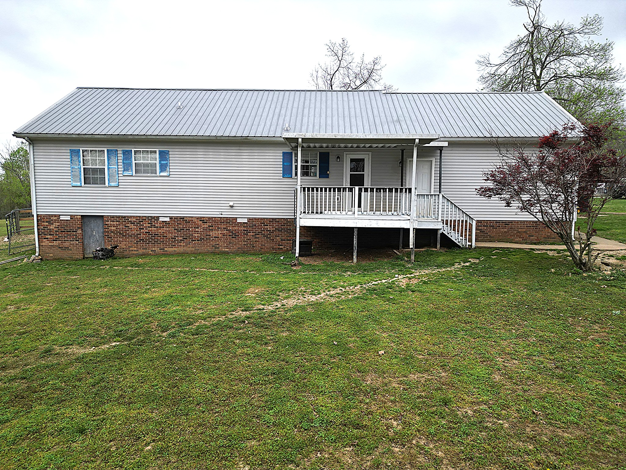 150 Deerwood Road Hohenwald, TN 38462 - Photo 6 of 56 a front view of a house with a garden and deck