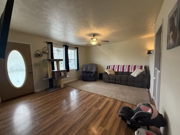 a view of a livingroom with furniture and wooden floor