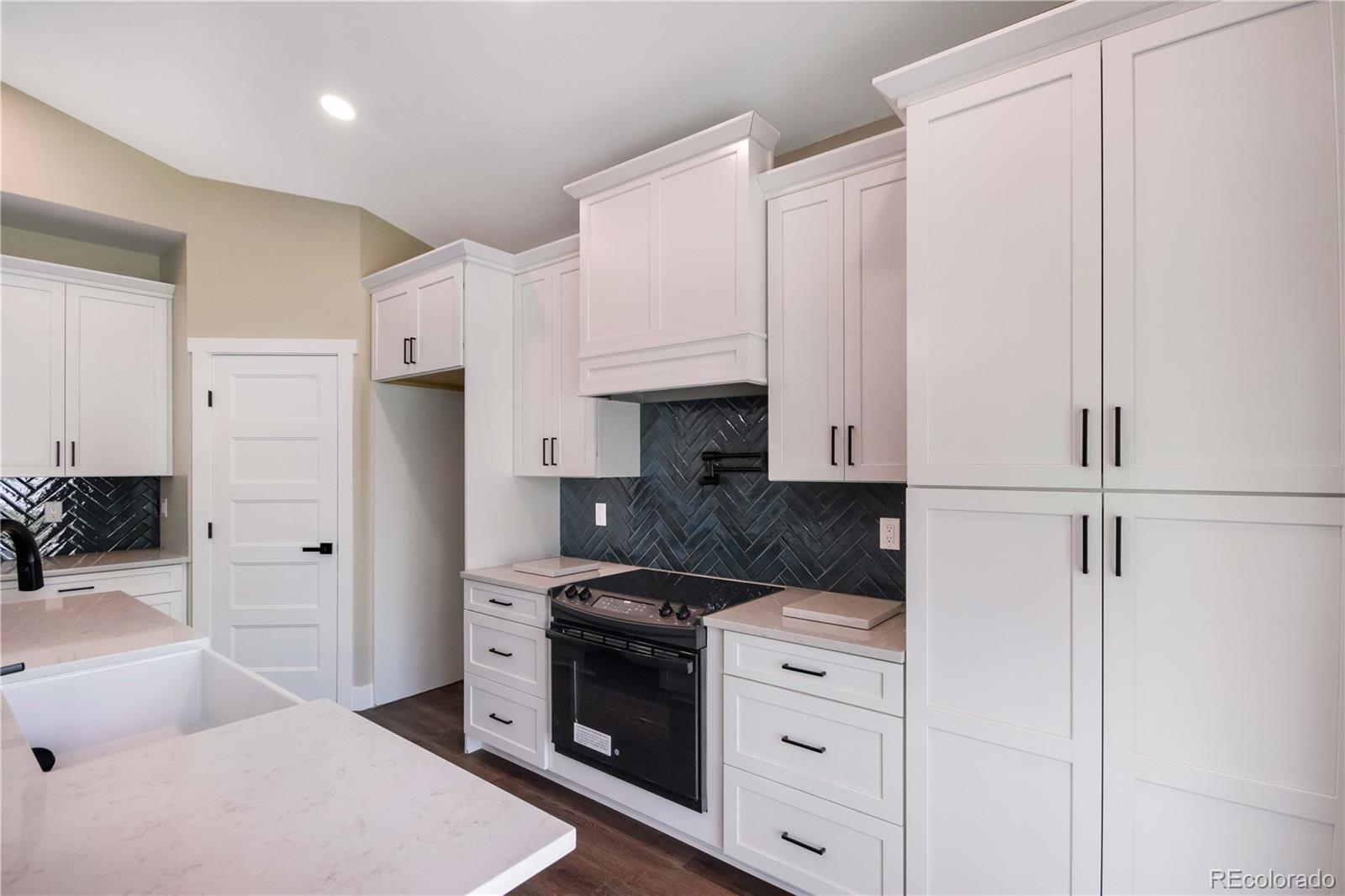 1220 Swainson Road Eaton, CO 80615 - Photo 13 of 35 a kitchen with cabinets appliances and a counter space