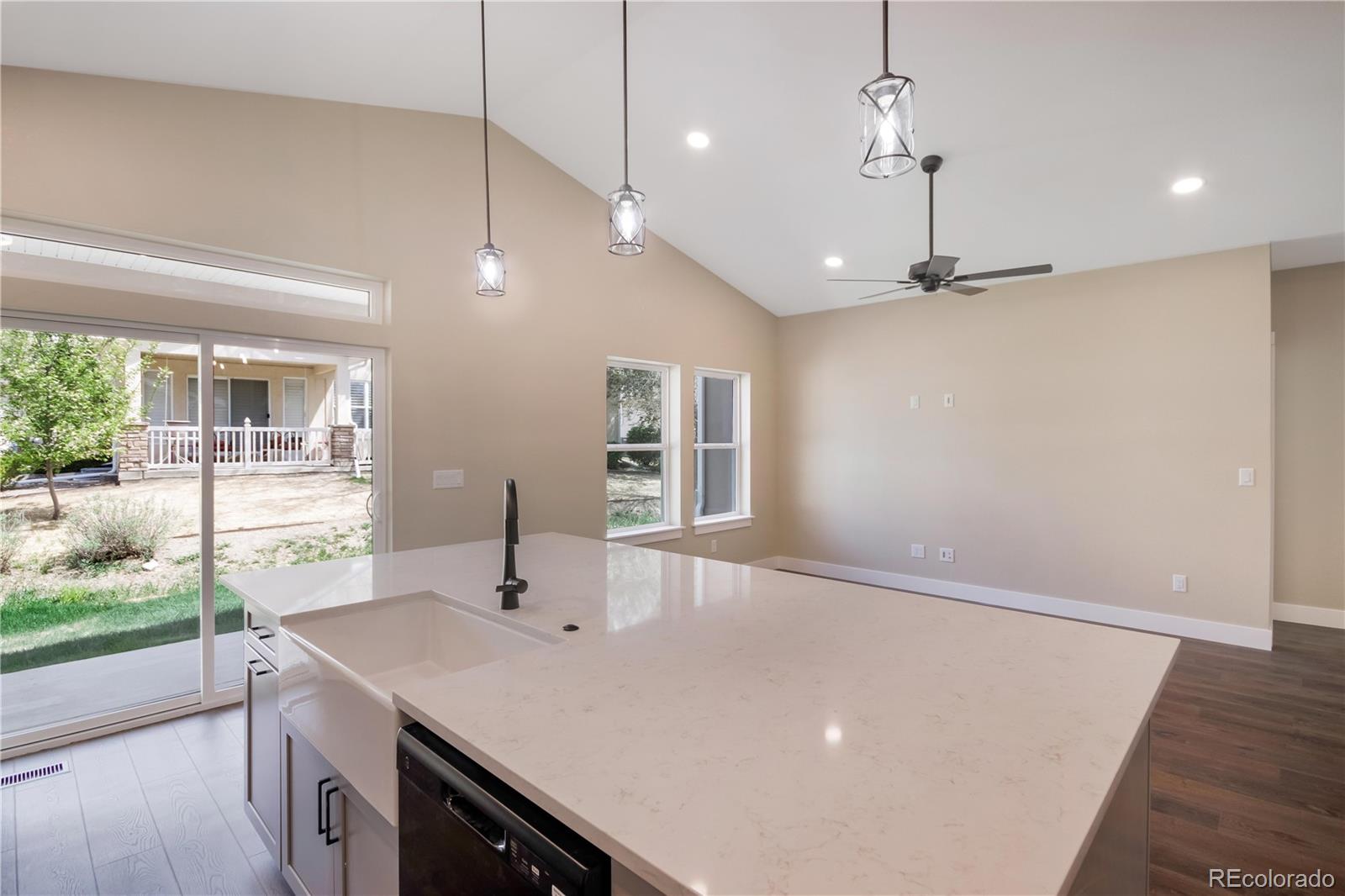 1220 Swainson Road Eaton, CO 80615 - Photo 16 of 35 a kitchen with a sink a window and wooden floor