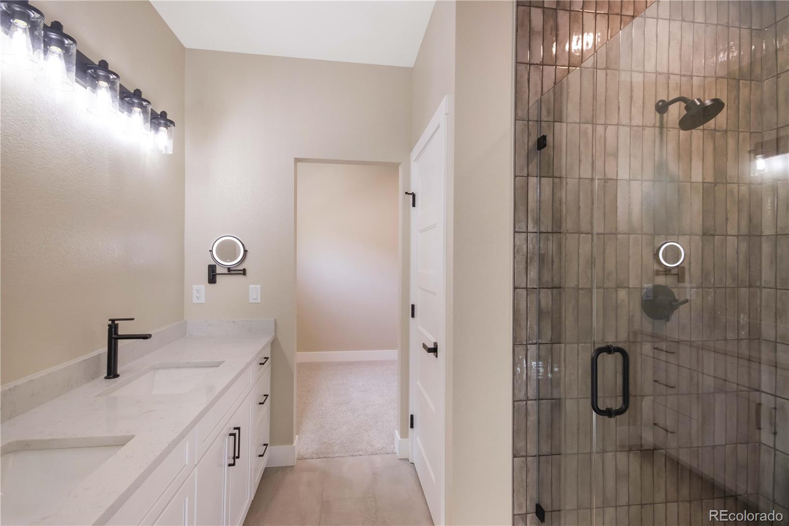 1220 Swainson Road Eaton, CO 80615 - Photo 19 of 35 a bathroom with a shower sink and mirror