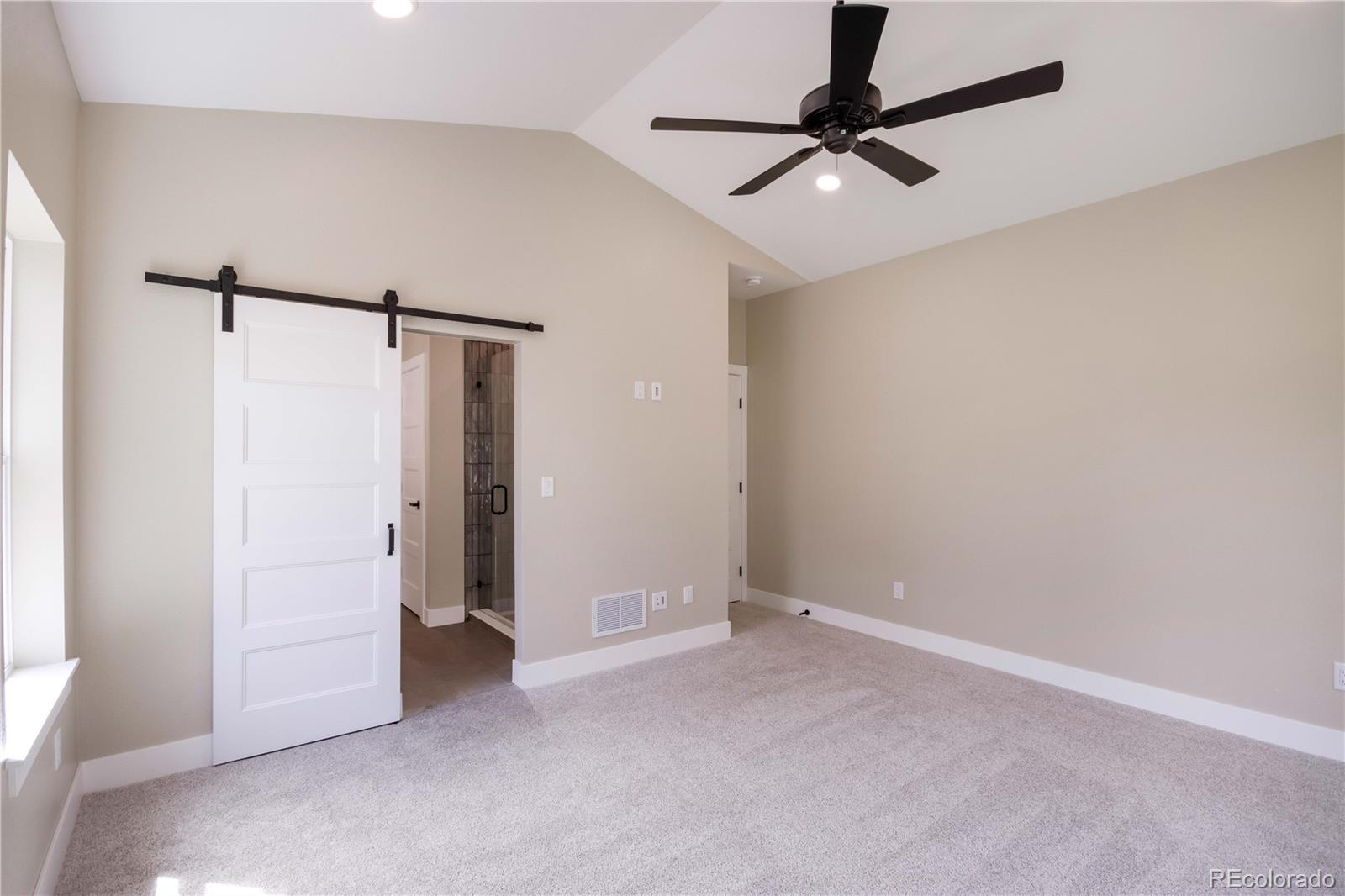 1220 Swainson Road Eaton, CO 80615 - Photo 22 of 35 a view of a room with a ceiling fan and a window