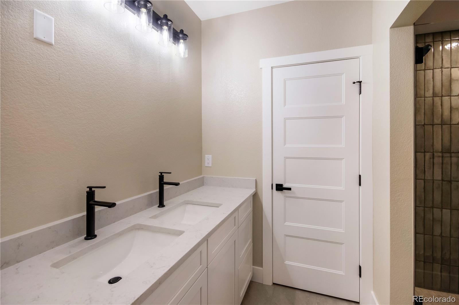 1220 Swainson Road Eaton, CO 80615 - Photo 29 of 35 a bathroom with a sink and a mirror