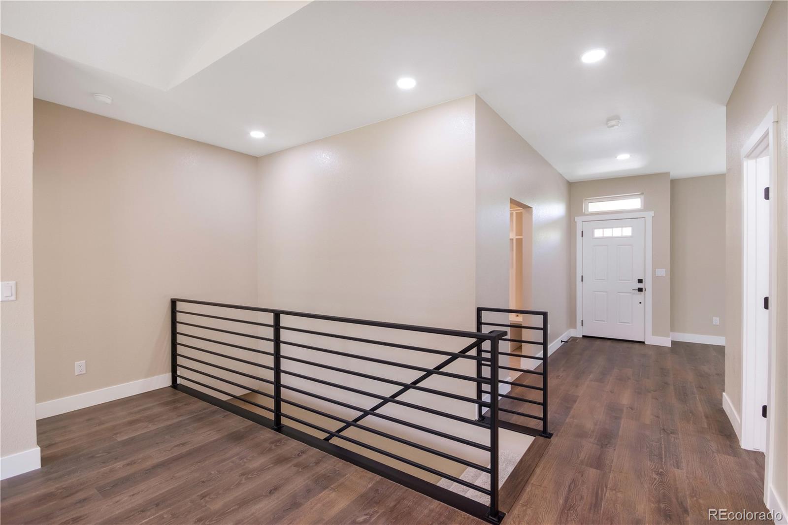 1220 Swainson Road Eaton, CO 80615 - Photo 7 of 35 a view of a hallway with wooden floor