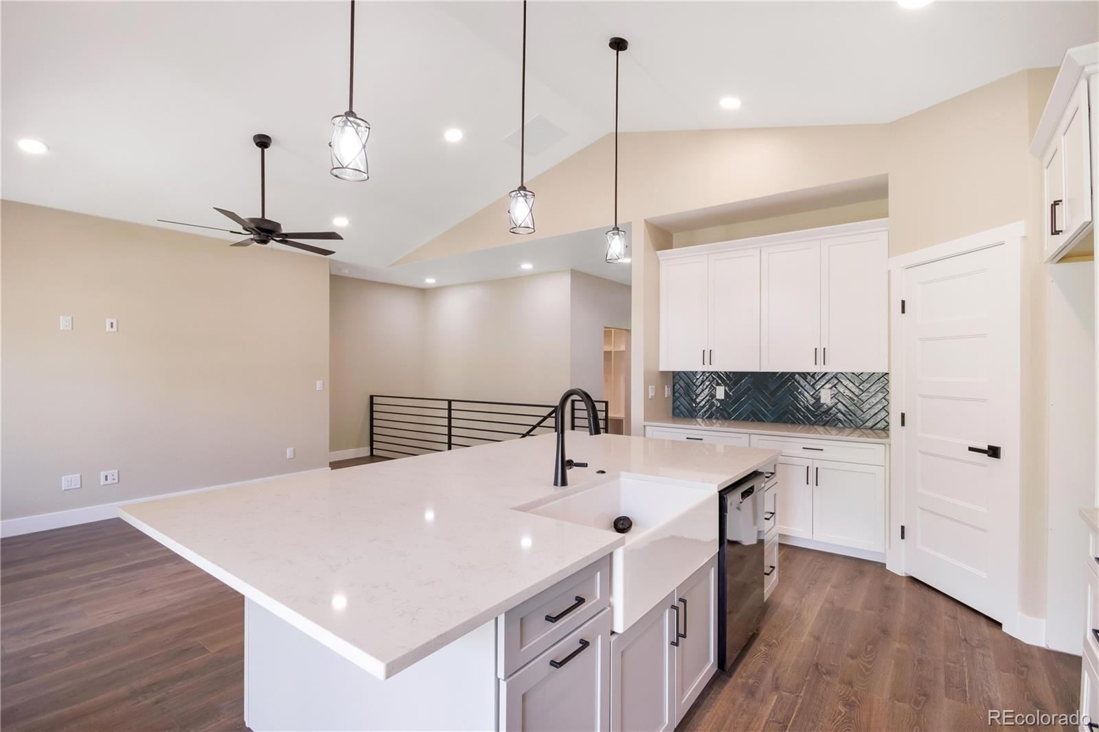 1220 Swainson Road Eaton, CO 80615 - Photo 9 of 35 a kitchen with a sink a counter space and wooden floor