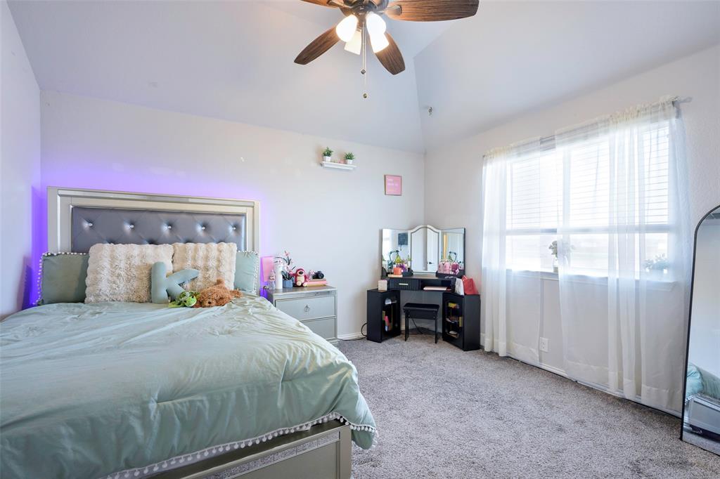 4059 Three Forks Road Kaufman, TX 75142 - Photo 20 of 25 a bedroom with a bed and a chandelier