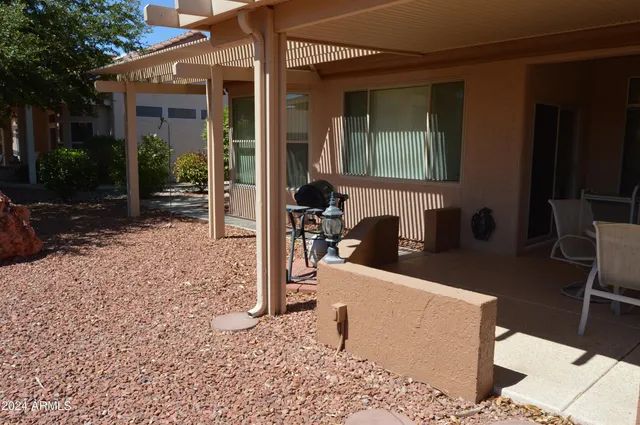 a view of a house with backyard porch and sitting area