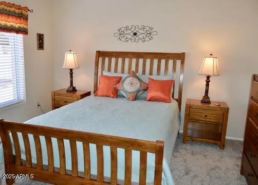 a bed sitting in a bedroom next to a lamp