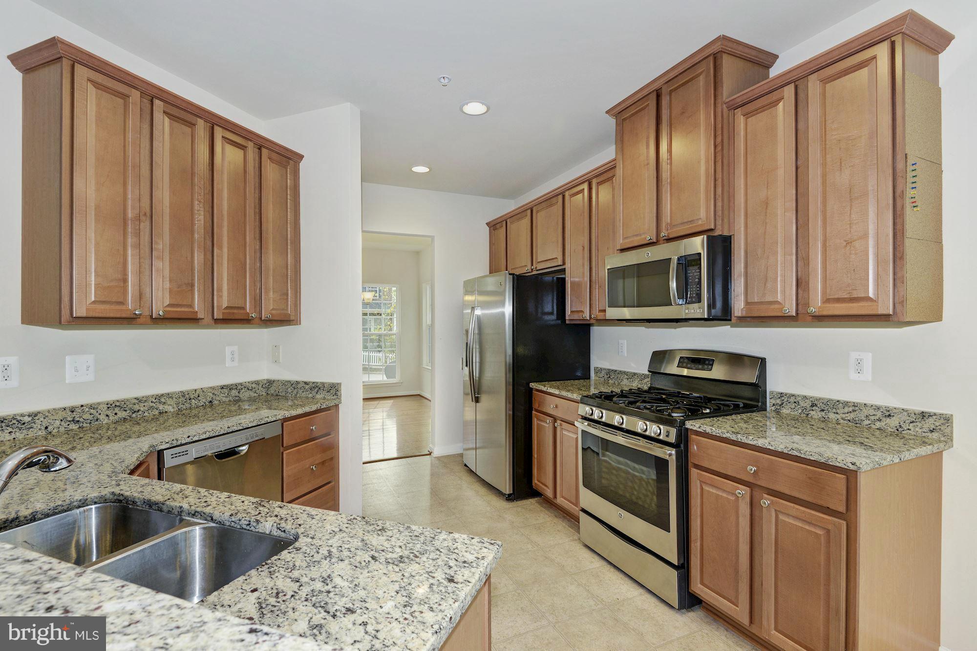 2644 St Marys View Road Accokeek, MD 20607 - Photo 12 of 29 a kitchen with stainless steel appliances granite countertop a sink stove microwave and refrigerator