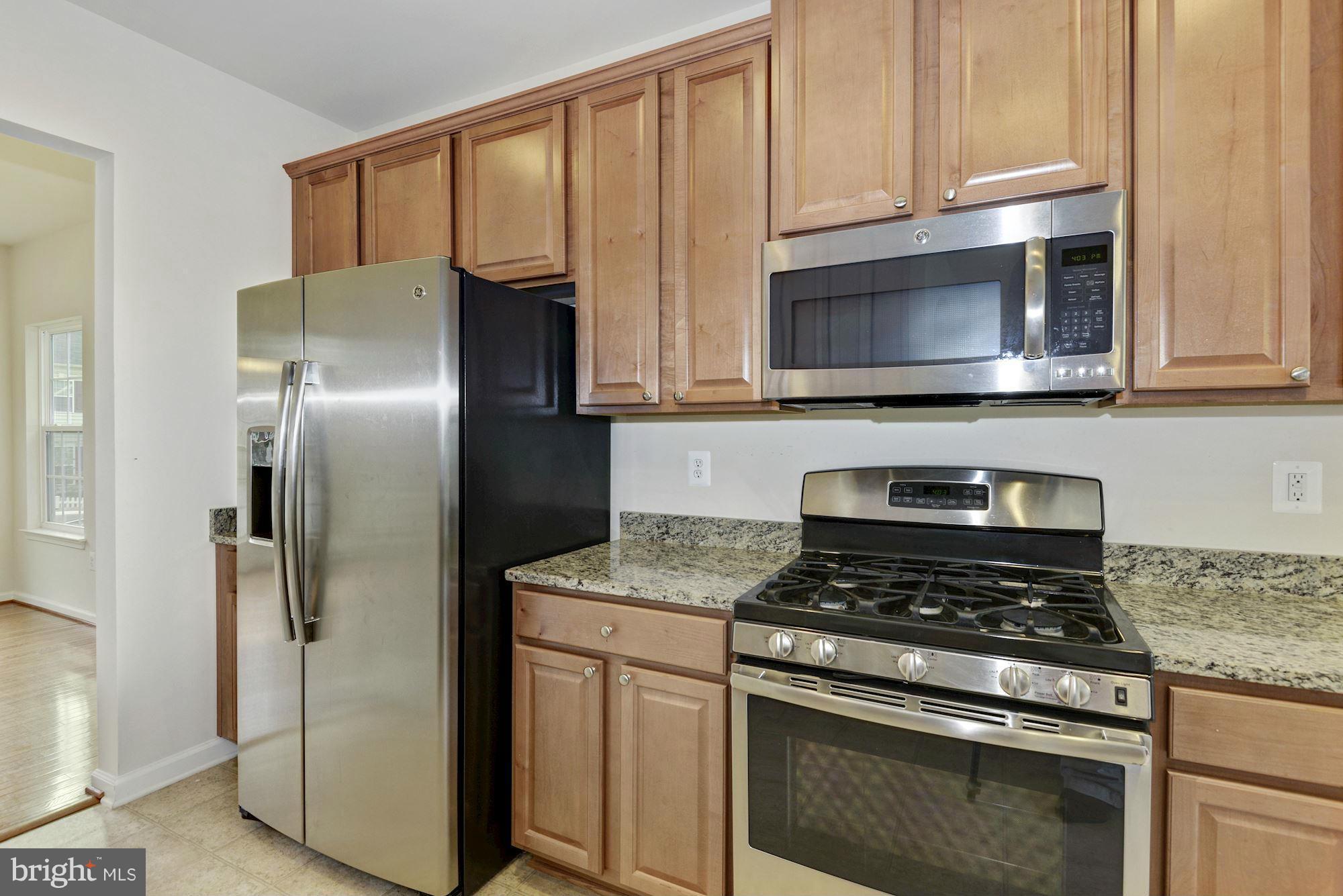 2644 St Marys View Road Accokeek, MD 20607 - Photo 14 of 29 a kitchen with stainless steel appliances granite countertop a stove microwave and refrigerator