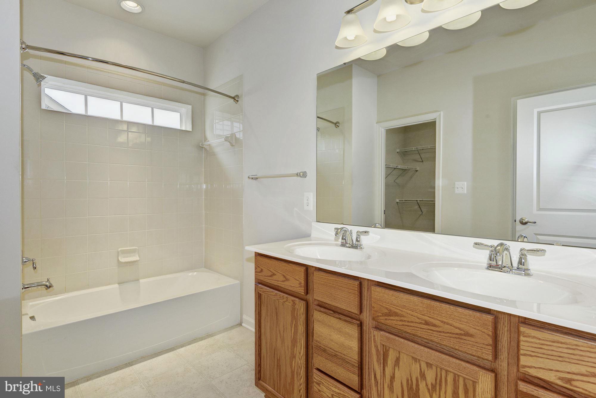 2644 St Marys View Road Accokeek, MD 20607 - Photo 18 of 29 a bathroom with a sink double vanity granite tub and a mirror