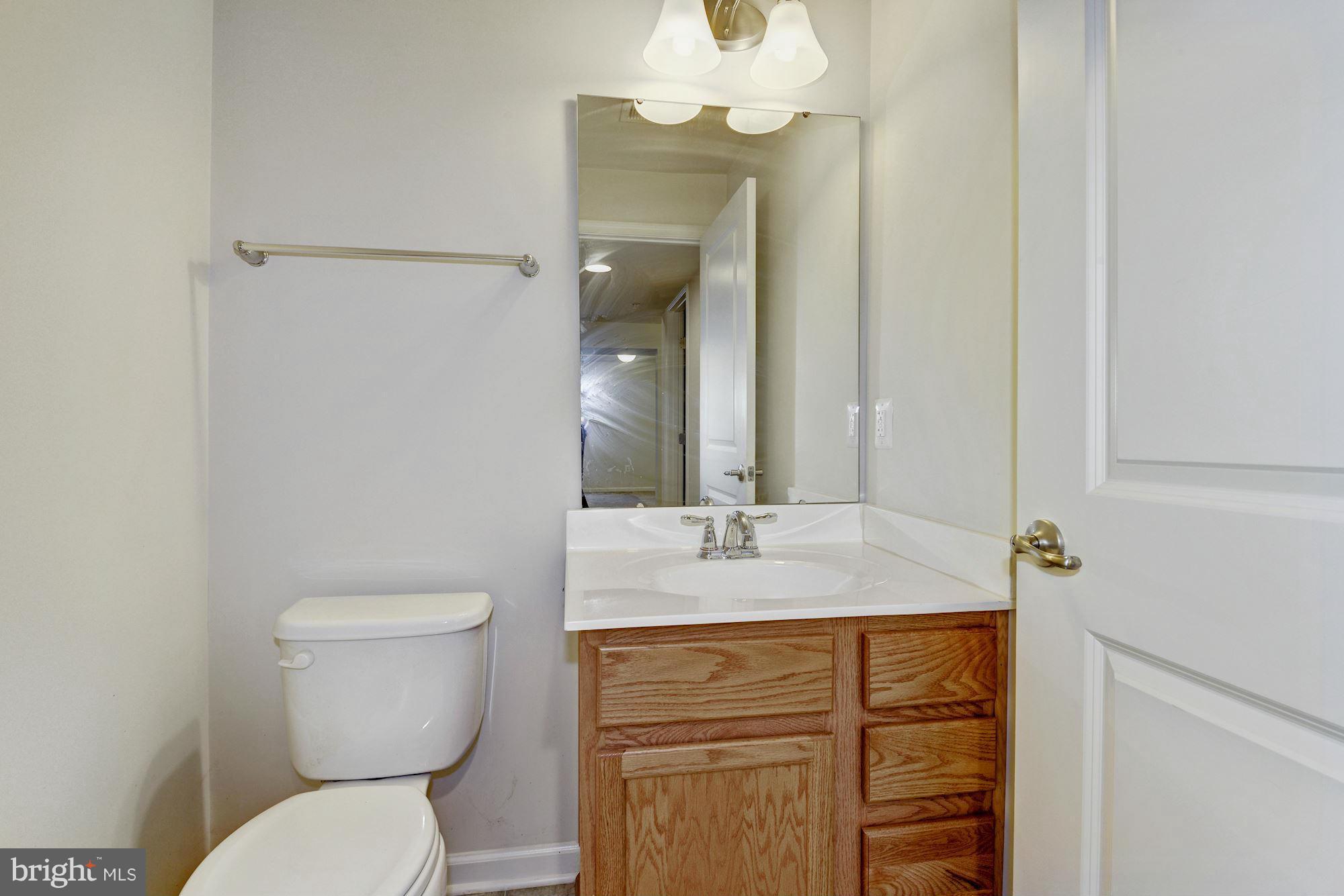 2644 St Marys View Road Accokeek, MD 20607 - Photo 29 of 29 a bathroom with a sink a toilet and a mirror
