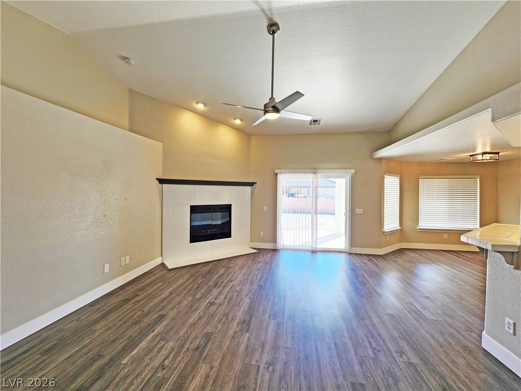 4591 Stoneham Street Pahrump, NV 89061 - Photo 11 of 42 A corner fireplace and sliding glass doors enhance this spacious, naturally illuminated living area.