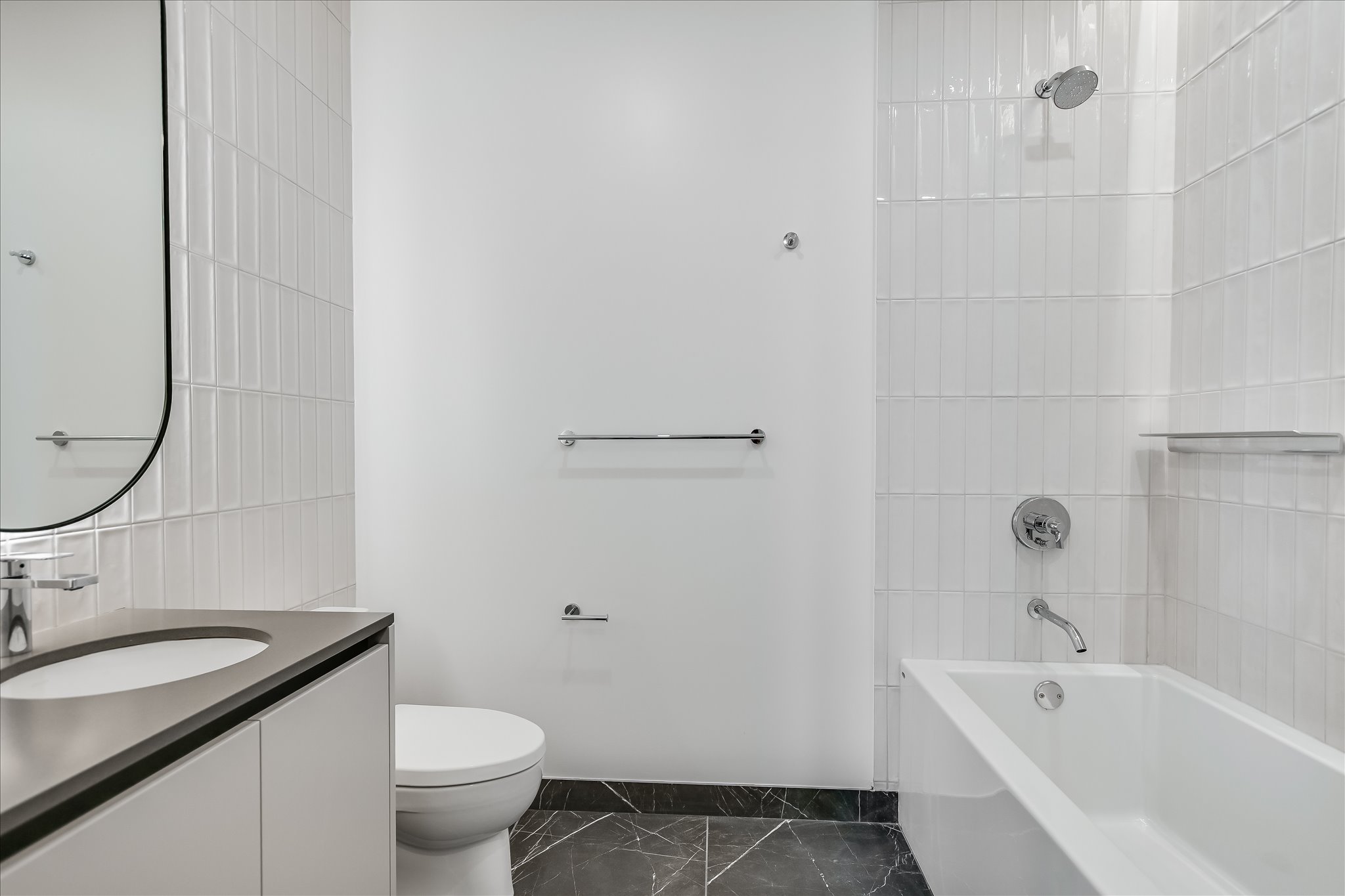 610 Davis Street, Unit 2705 Austin, TX 78701 - Photo 14 of 33 a bathroom with a granite countertop sink a toilet and bathtub