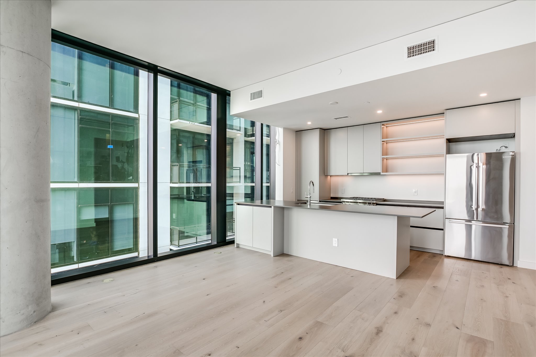 610 Davis Street, Unit 2705 Austin, TX 78701 - Photo 6 of 33 a kitchen with stainless steel appliances granite countertop a refrigerator and a sink