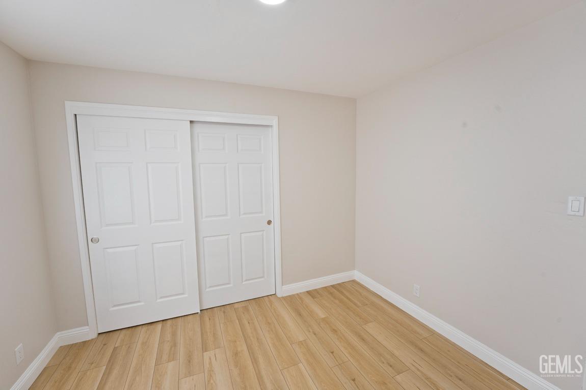 Undisclosed Address Bakersfield, CA 93304 - Photo 12 of 20 a view of an empty room with wooden floor