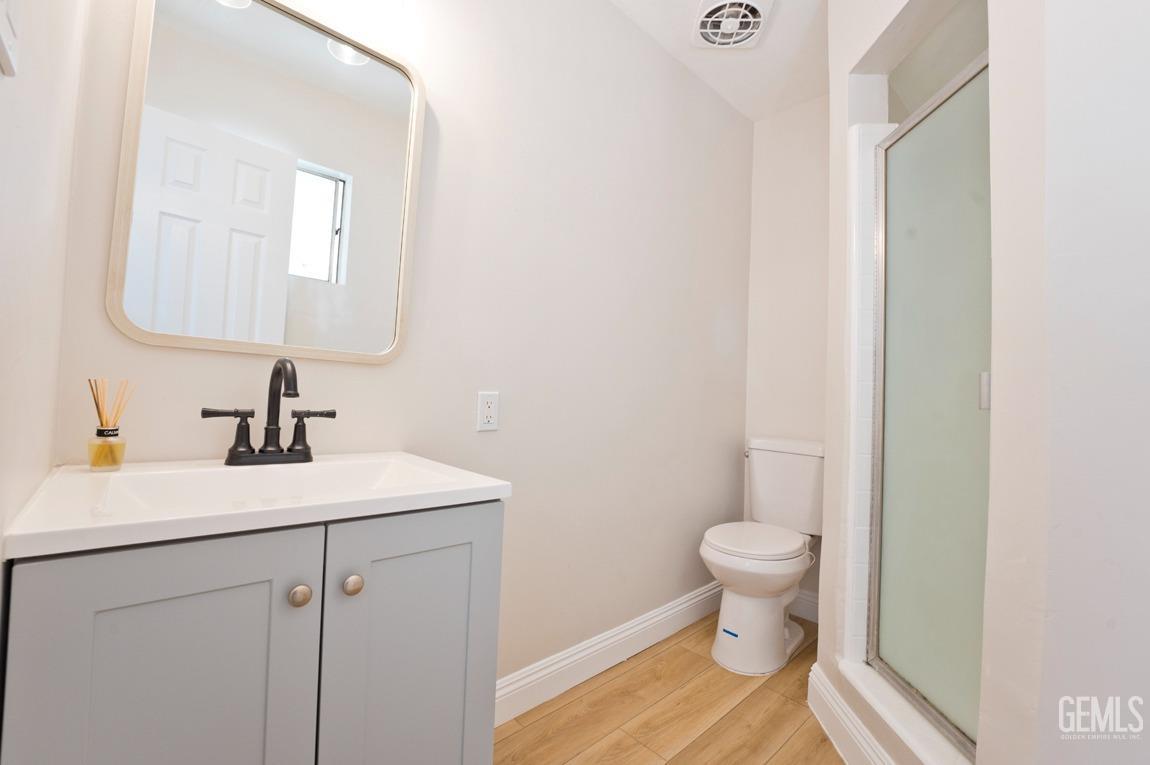 Undisclosed Address Bakersfield, CA 93304 - Photo 14 of 20 a bathroom with a sink a toilet and a mirror