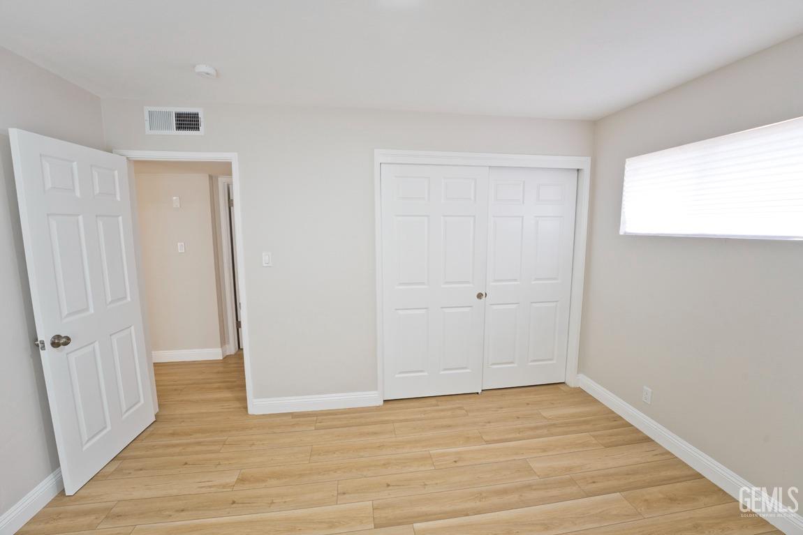 Undisclosed Address Bakersfield, CA 93304 - Photo 15 of 20 a view of an empty room with wooden floor